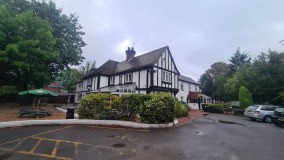 The Tudor Hotel & Bars logo
