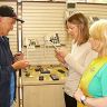 Staff showing specialist equipment for blind people to client