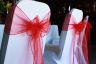 Spandex chair covers with red organza sashes