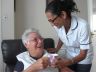 Care worker providing a drink for the Service User