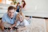 dad-and-daughter-playing-on-rug-min
