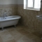 Travatine tiles with freestanding bath