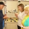 Staff showing specialist equipment for blind people to client