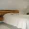 Unique bespoke headboard made from bark-edged timber